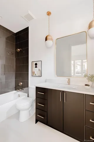 a bathroom with a toilet a sink and a mirror