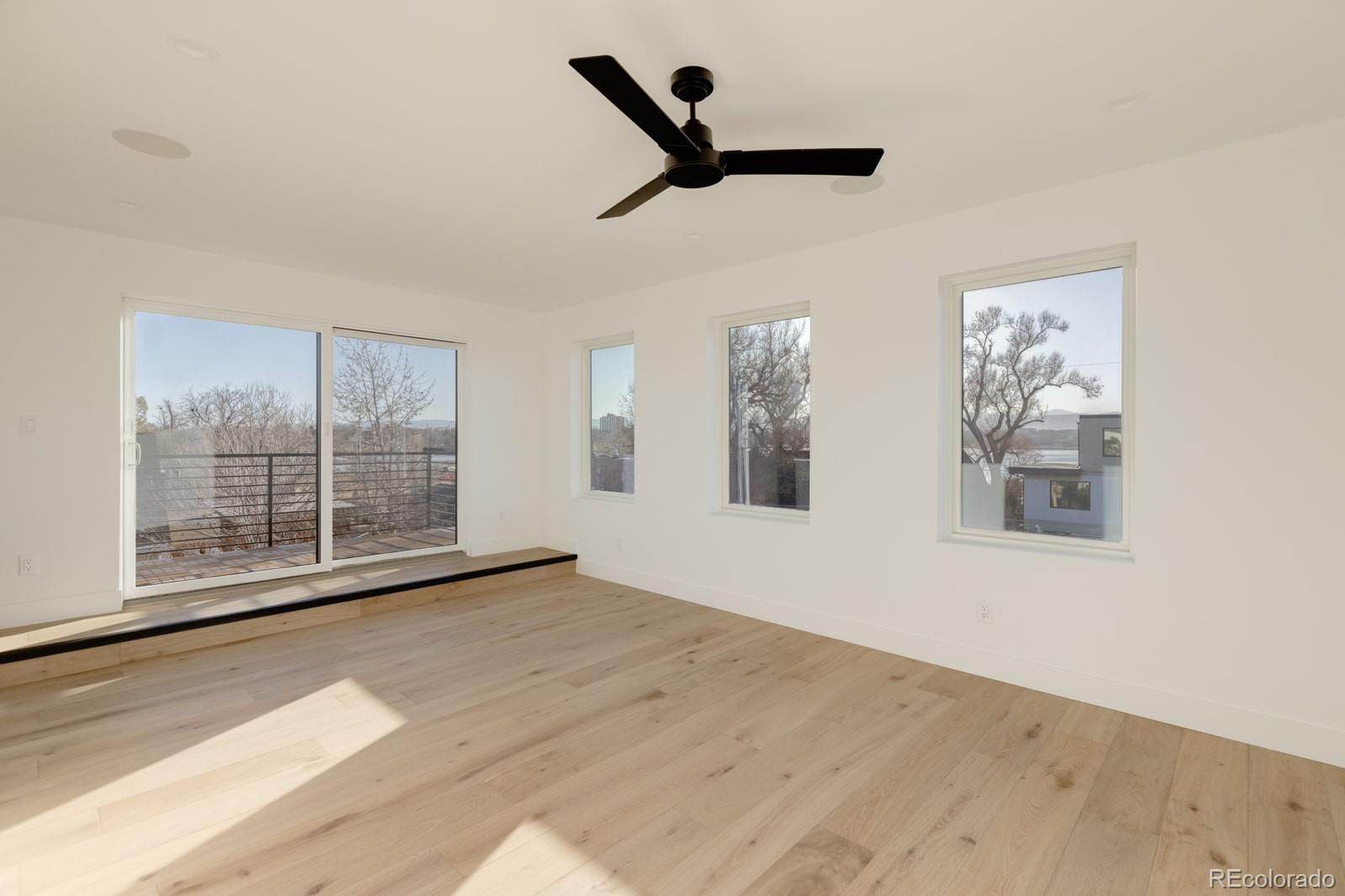 2112 Perry Street Denver, CO 80212 - Photo 27 of 49 a view of empty room with wooden floor and fan