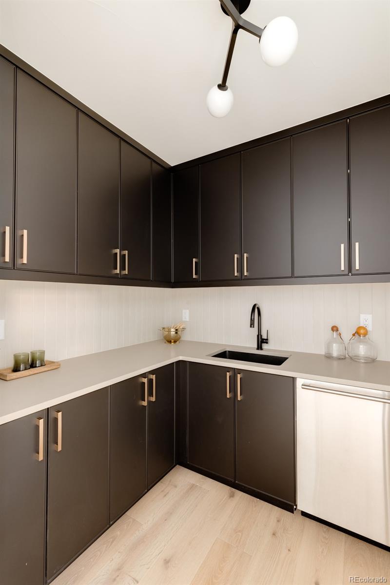 2112 Perry Street Denver, CO 80212 - Photo 8 of 49 a kitchen with a sink and cabinets