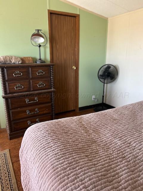 207 North Street Claude, TX 79019 - Photo 11 of 27 a bedroom with a bed and a chandelier