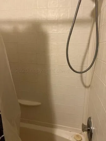 a utility room with a shower curtain and a sink