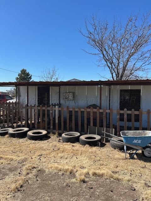 207 North Street Claude, TX 79019 - Photo 21 of 27 a view of a backyard with a bench and wooden fence