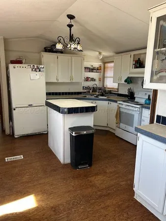 a kitchen with a stove and white cabinets