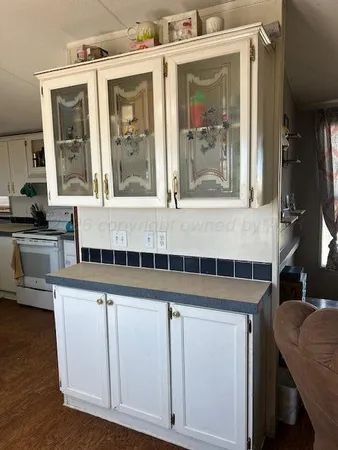 a kitchen with cabinets and outdoor view