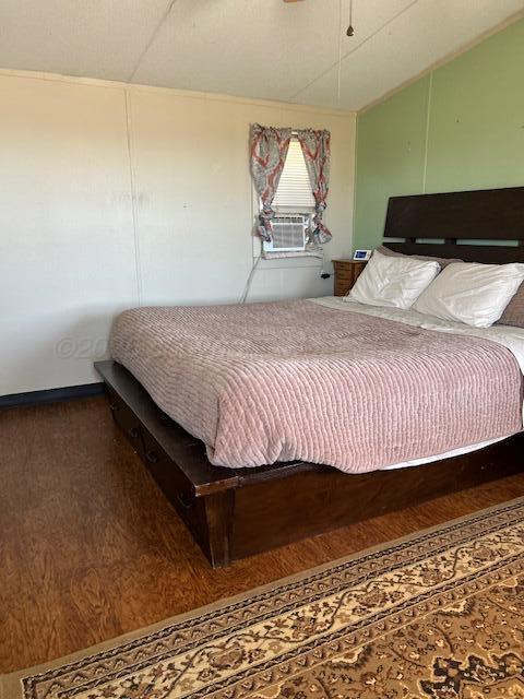 207 North Street Claude, TX 79019 - Photo 9 of 27 a bedroom with a bed and wooden floor