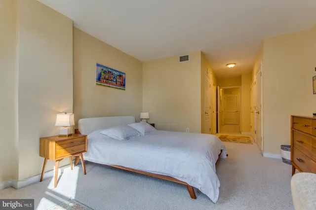 a bedroom with a bed and a lamp on table