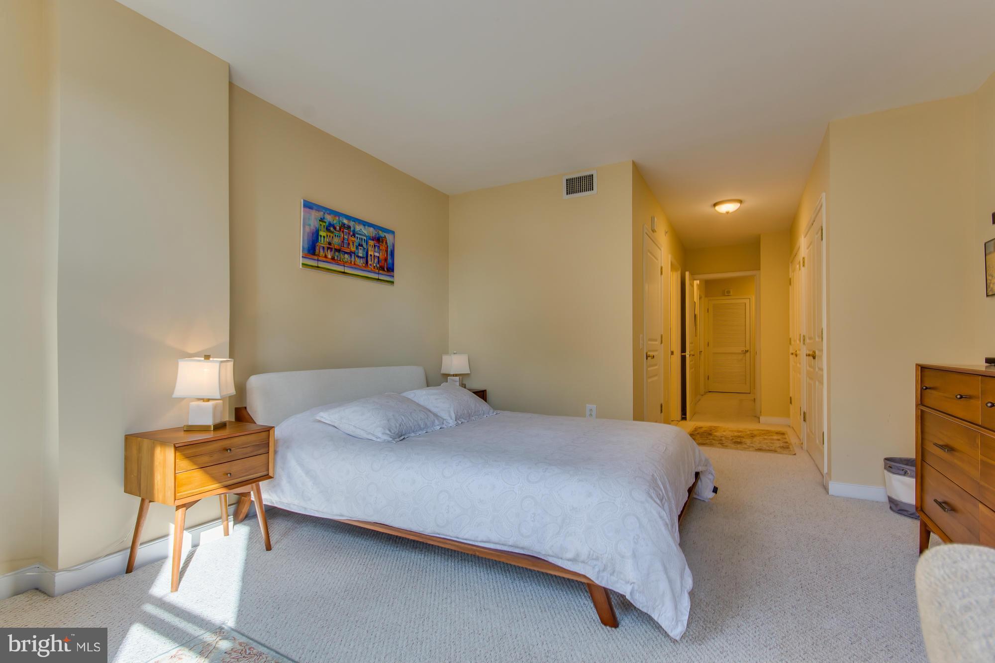 631 D Street Northwest, Unit 845 Washington, DC 20004 - Photo 11 of 30 a bedroom with a bed and a lamp on table
