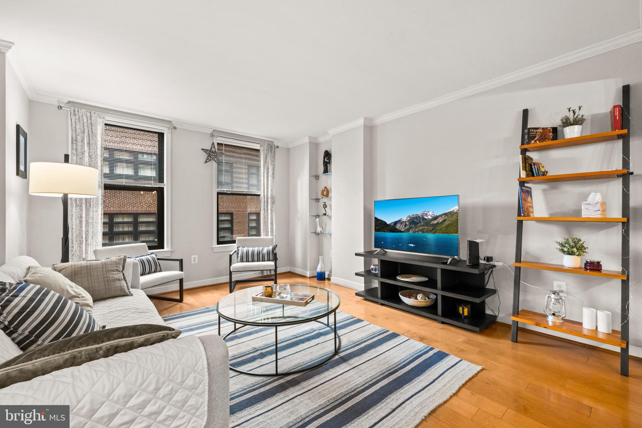 631 D Street Northwest, Unit 845 Washington, DC 20004 - Photo 11 of 84 a living room with furniture and a flat screen tv