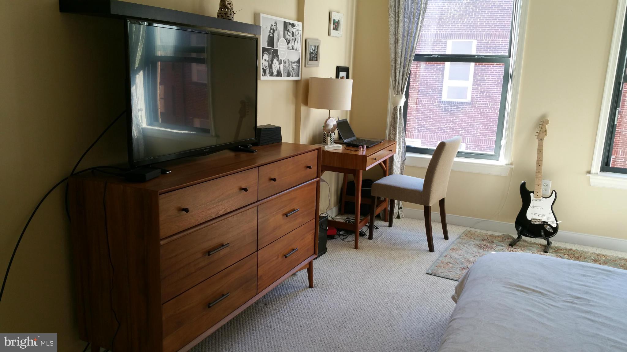 631 D Street Northwest, Unit 845 Washington, DC 20004 - Photo 12 of 30 a room with mirror and furniture