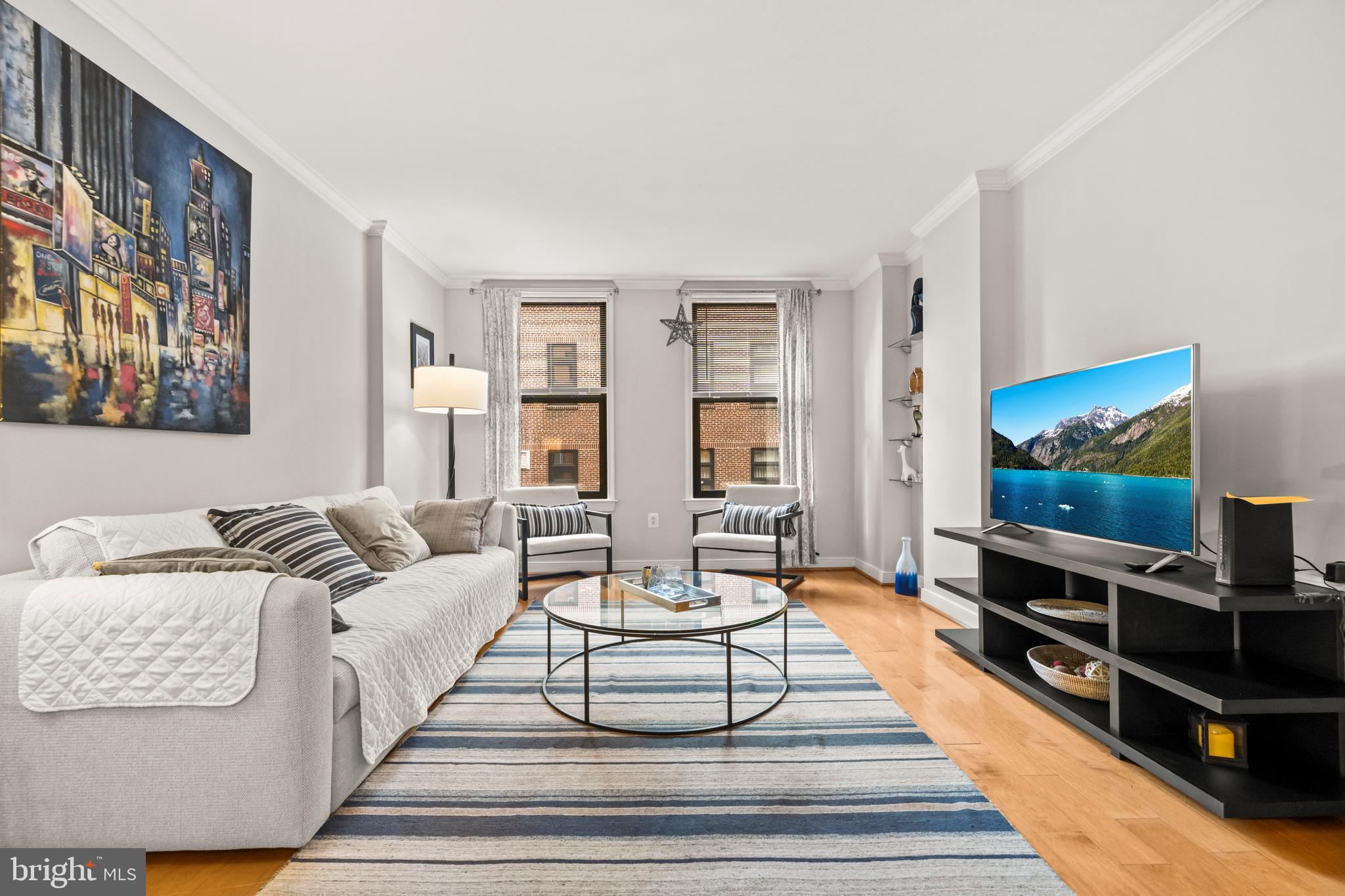 631 D Street Northwest, Unit 845 Washington, DC 20004 - Photo 13 of 84 a living room with furniture and a flat screen tv