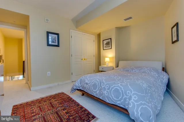 a bedroom with a bed and a potted plant