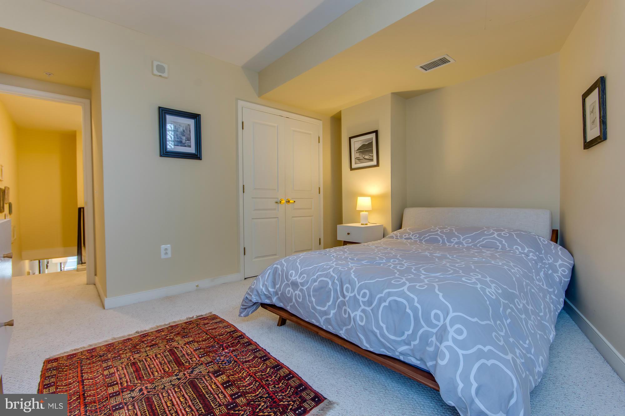 631 D Street Northwest, Unit 845 Washington, DC 20004 - Photo 13 of 30 a bedroom with a bed and a potted plant