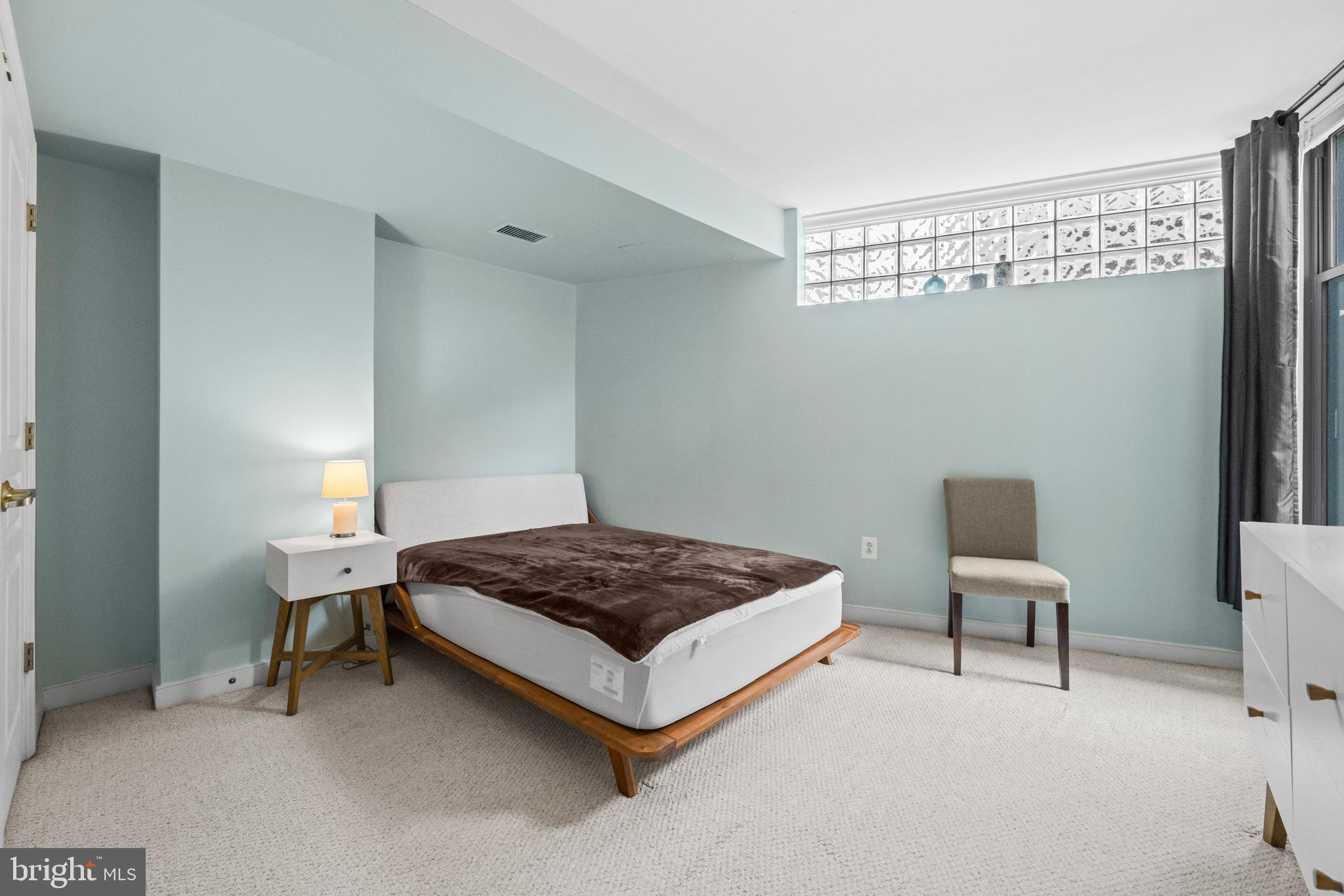 631 D Street Northwest, Unit 845 Washington, DC 20004 - Photo 19 of 84 a spacious bedroom with a bed and chair