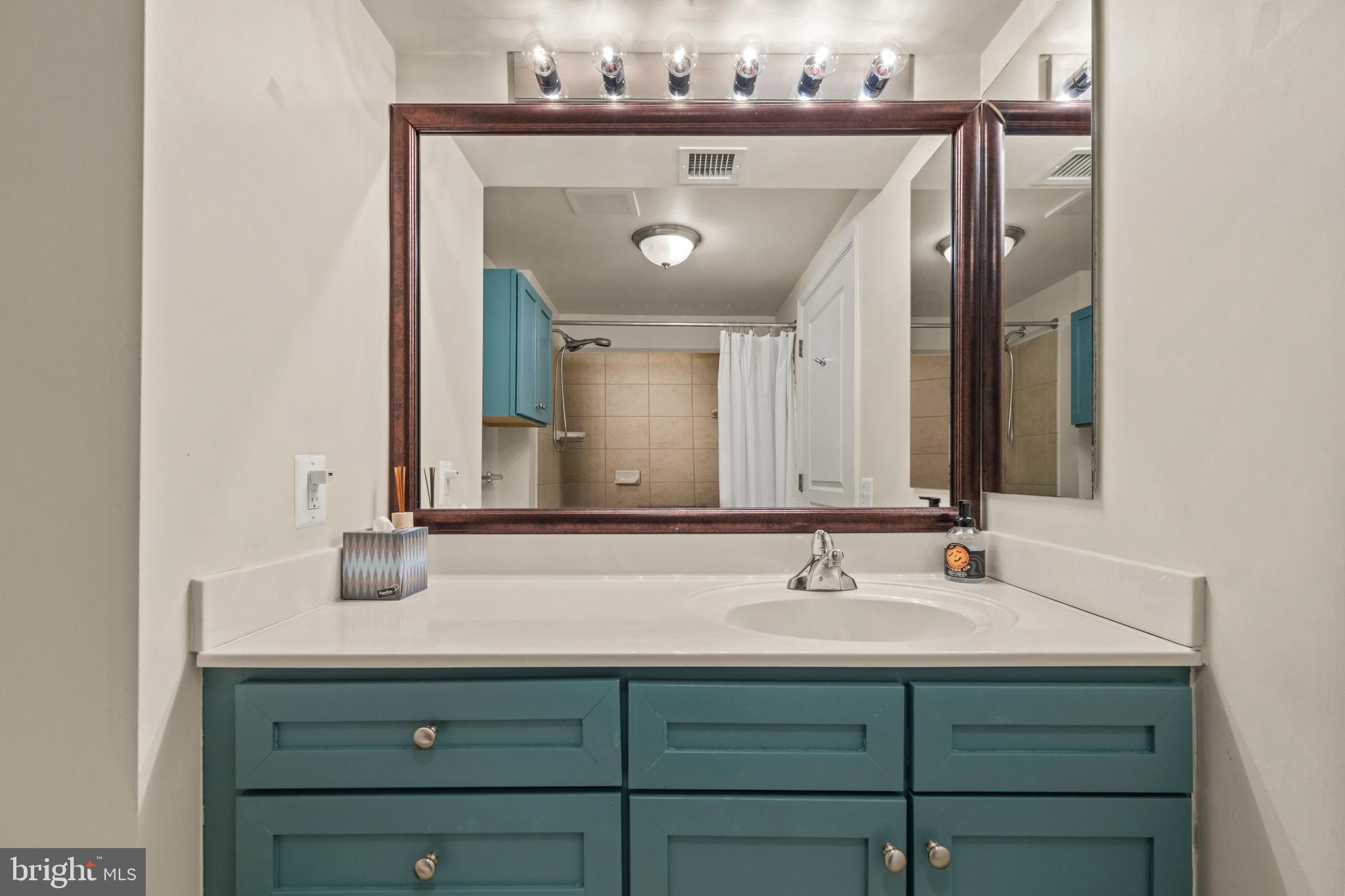 631 D Street Northwest, Unit 845 Washington, DC 20004 - Photo 25 of 84 a bathroom with a sink vanity and a mirror