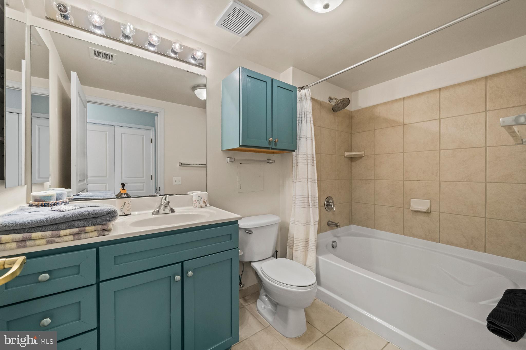 631 D Street Northwest, Unit 845 Washington, DC 20004 - Photo 33 of 84 a bathroom with a granite countertop sink toilet mirror and bathtub