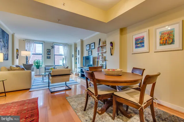 a dining room with furniture and wooden floor
