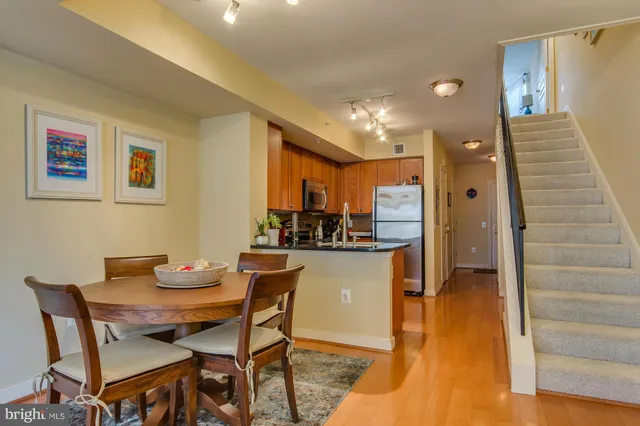 a dining room with furniture and a wooden floor