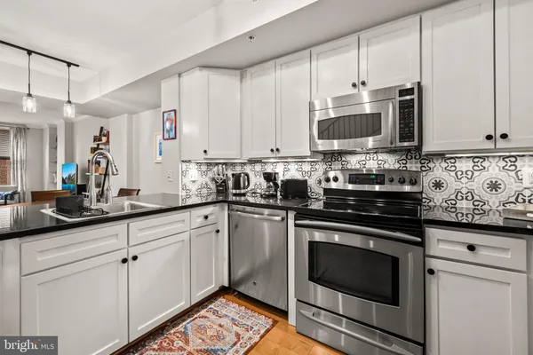 a dining room with stainless steel appliances kitchen island a table and chairs