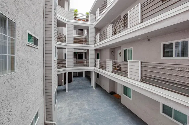 a view of a house with a barbeque and more windows
