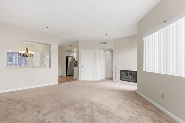a view of a livingroom with wooden floor and a fireplace
