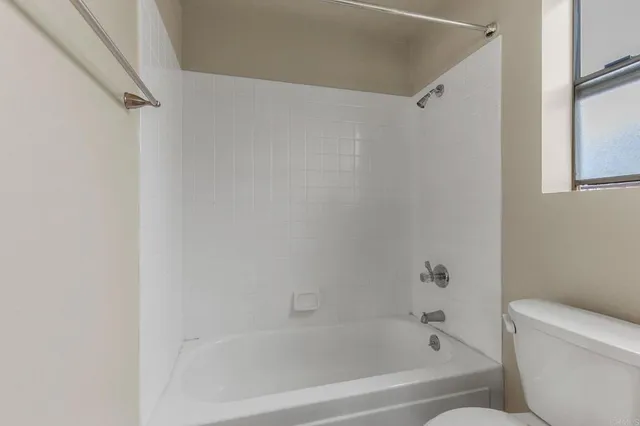 a bathroom with a bathtub and a toilet