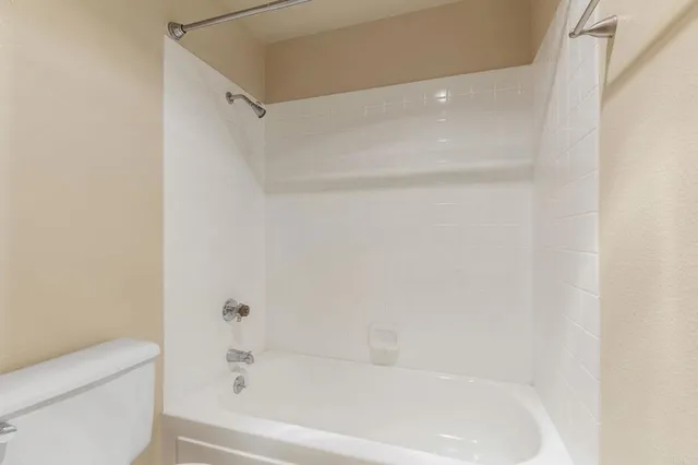 a bathroom with a bathtub and a toilet