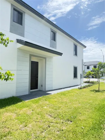 a view of an house with backyard space and balcony