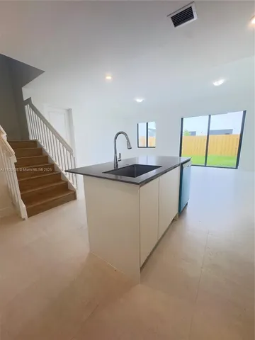 a kitchen with stainless steel appliances granite countertop a sink and a stove top oven