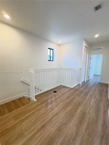 a view of a room with wooden floor