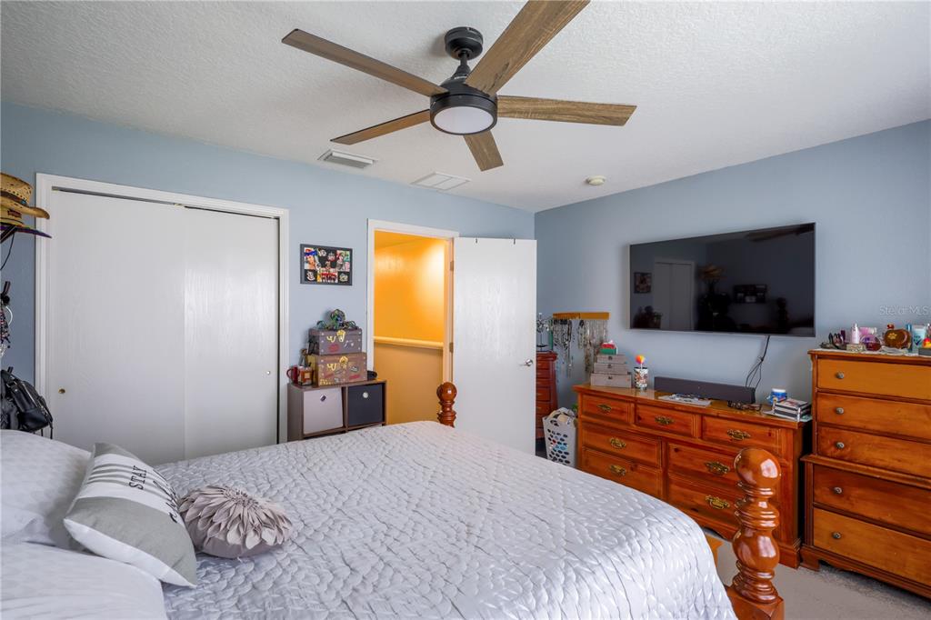 6925 Marble Fawn Place Riverview, FL 33578 - Photo 16 of 21 a bedroom with a bed and a flat screen tv