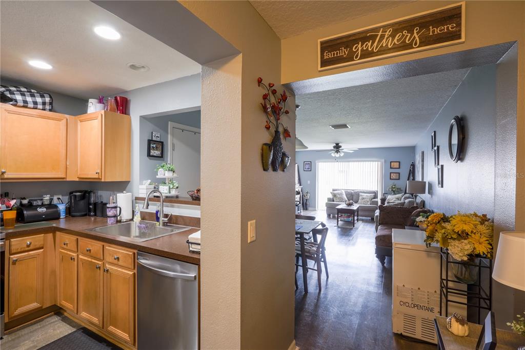 6925 Marble Fawn Place Riverview, FL 33578 - Photo 6 of 21 a kitchen with sink refrigerator and cabinets