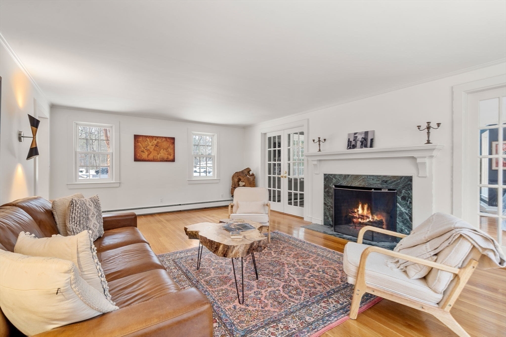 56 Isaac Davis Road Concord, MA 01742 - Photo 13 of 42 a living room with furniture and a fireplace