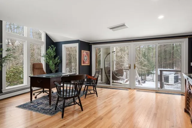 a dining room with furniture window and wooden floor
