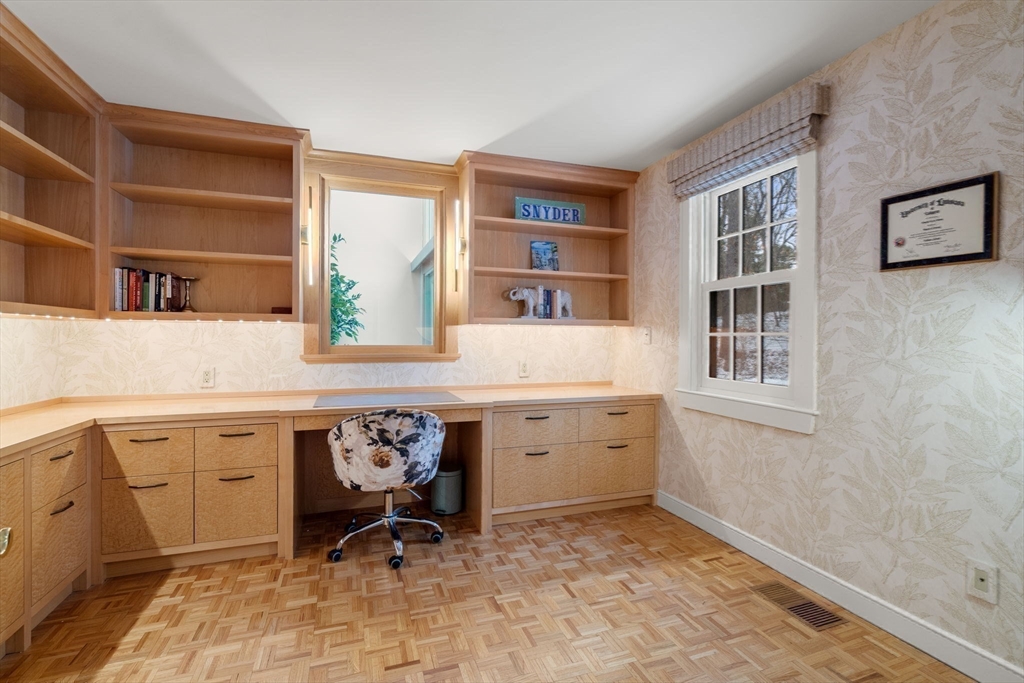 56 Isaac Davis Road Concord, MA 01742 - Photo 17 of 42 a room with a window cabinets and chair