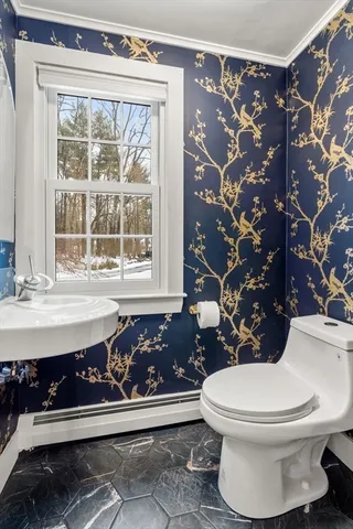 a bathroom with a toilet sink and mirror