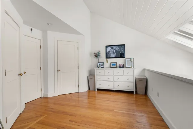 a view of a bedroom with baby bed and workspace