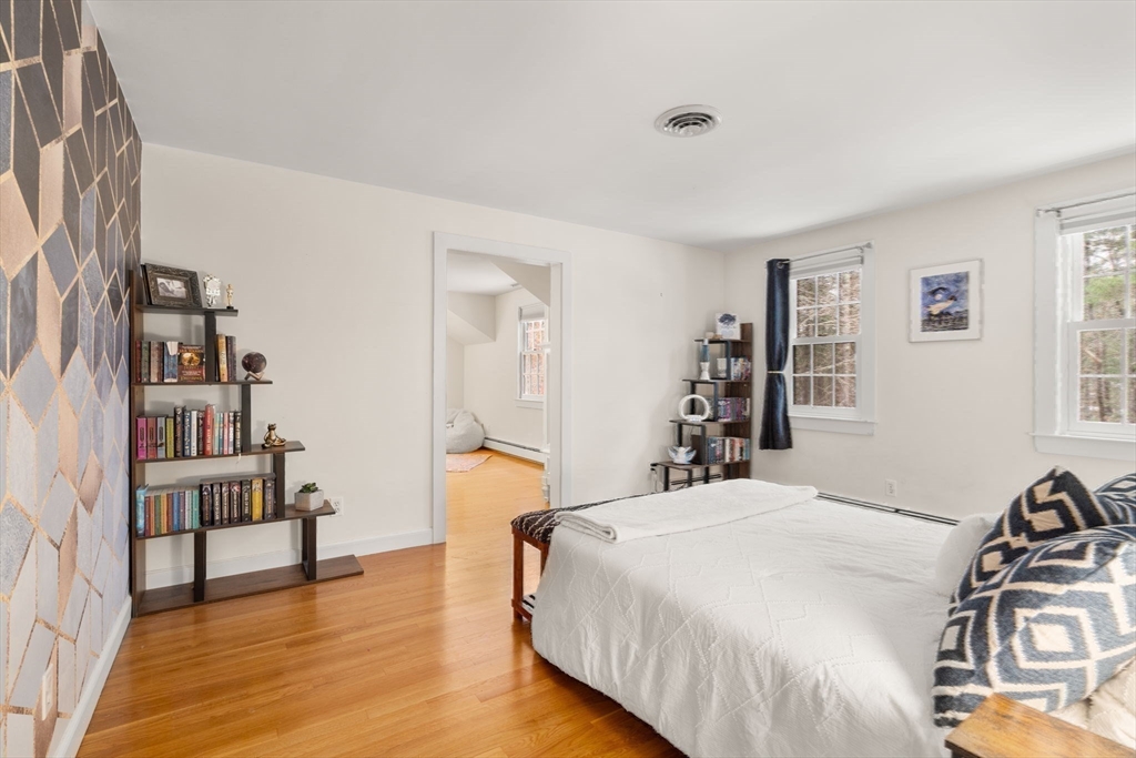 56 Isaac Davis Road Concord, MA 01742 - Photo 23 of 42 a bedroom with a bed and a book shelf
