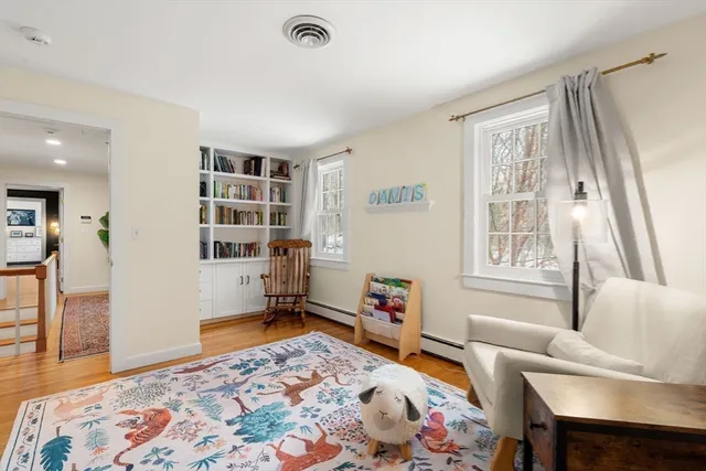 a bedroom with furniture and a rug