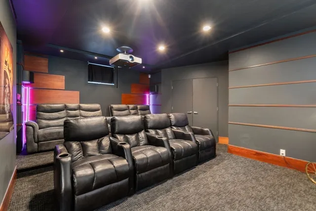 a media room with lots of chairs and a projector