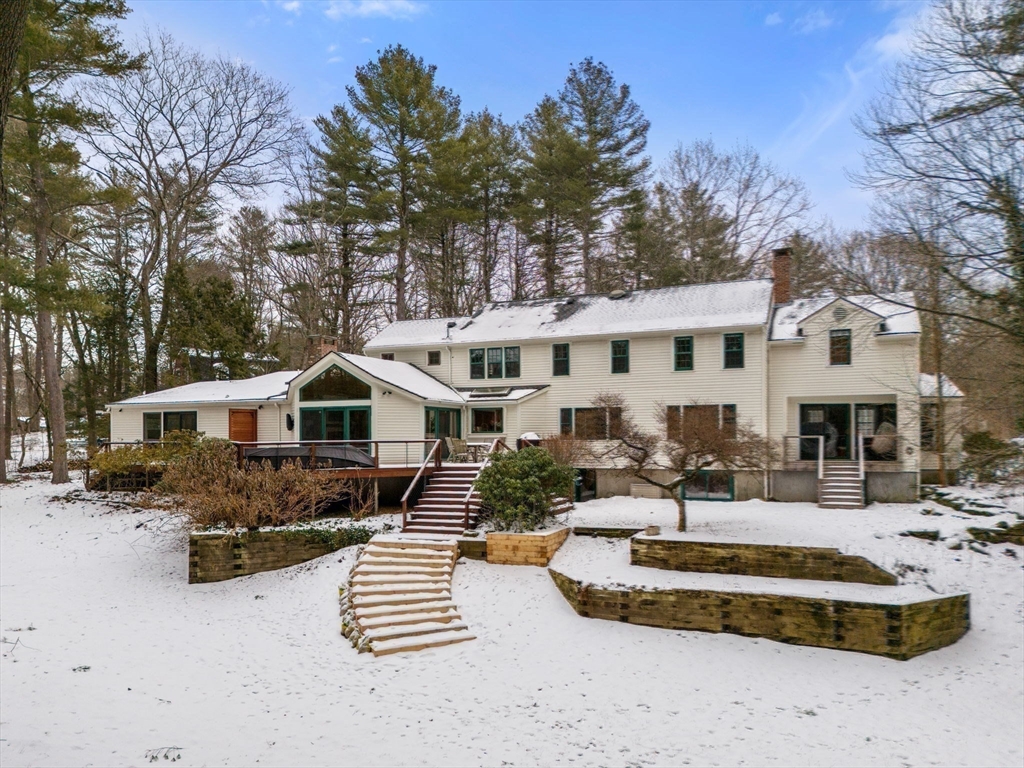 56 Isaac Davis Road Concord, MA 01742 - Photo 32 of 42 a front view of a house with a yard covered in snow
