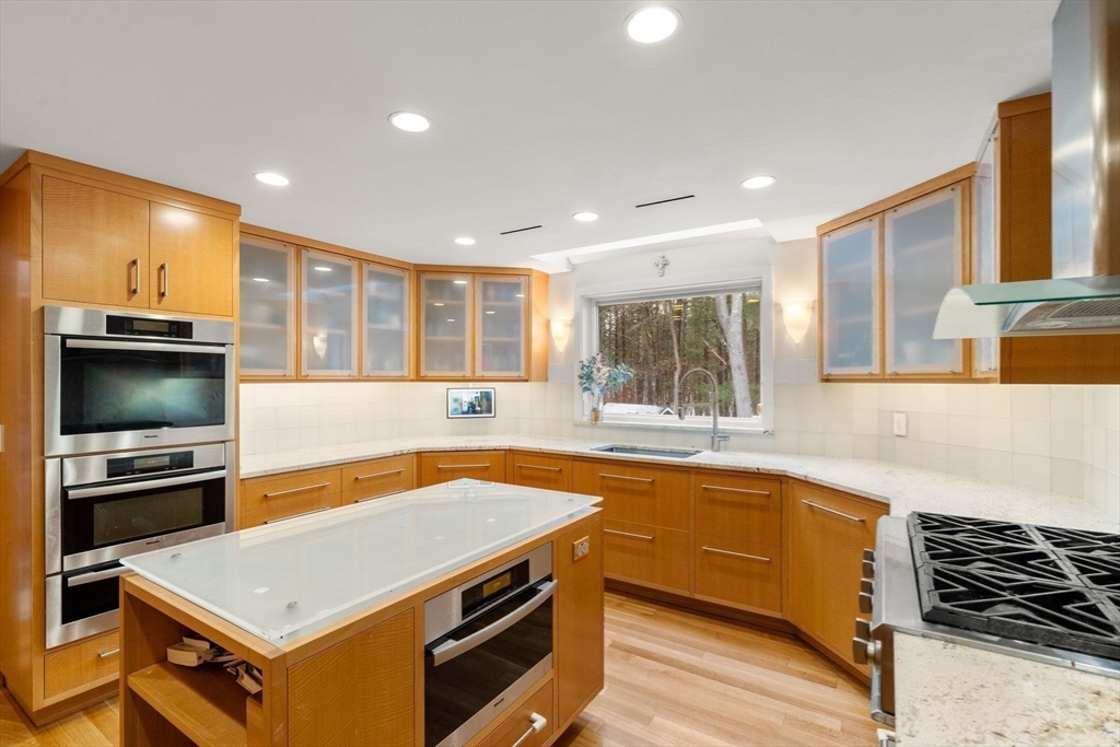 56 Isaac Davis Road Concord, MA 01742 - Photo 6 of 42 a kitchen with a stove and a sink