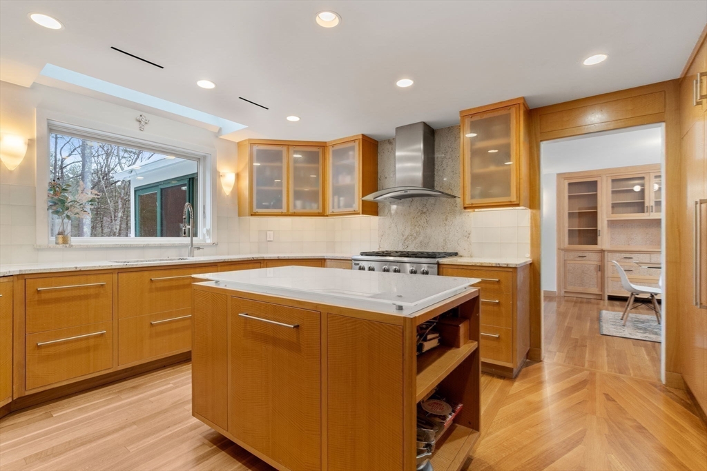 56 Isaac Davis Road Concord, MA 01742 - Photo 7 of 42 a kitchen with granite countertop a sink and a stove top oven