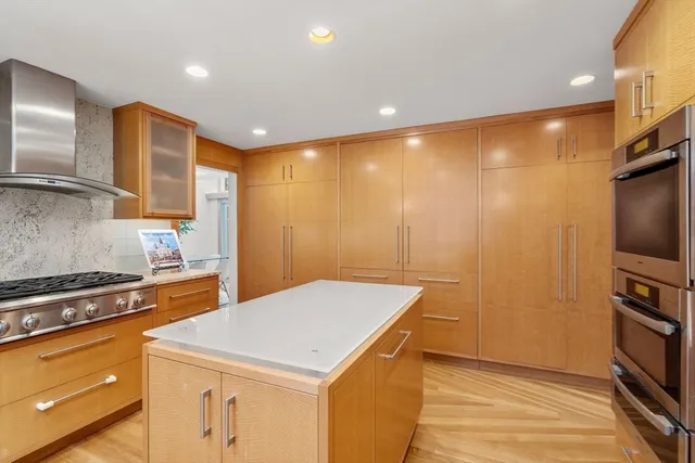 a kitchen that has a sink a stove and a refrigerator