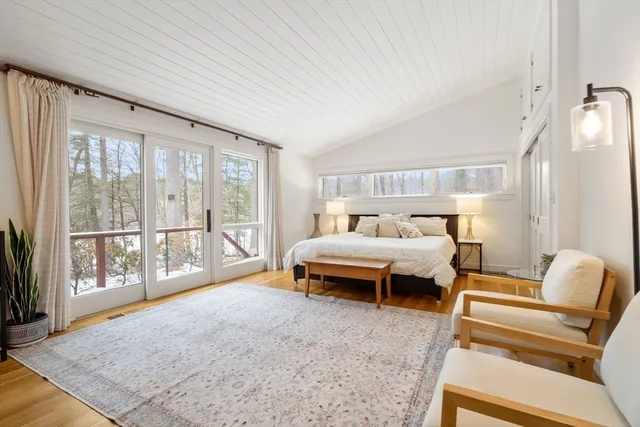 a bedroom with furniture and large windows