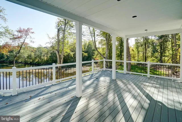 a view of a balcony with lake view and a floor to ceiling window