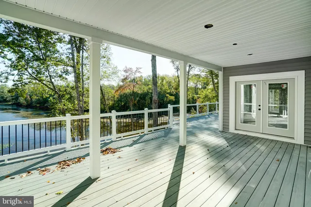 a view of balcony with wooden floor and fence