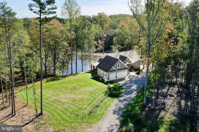 a front view of a house with cars parked
