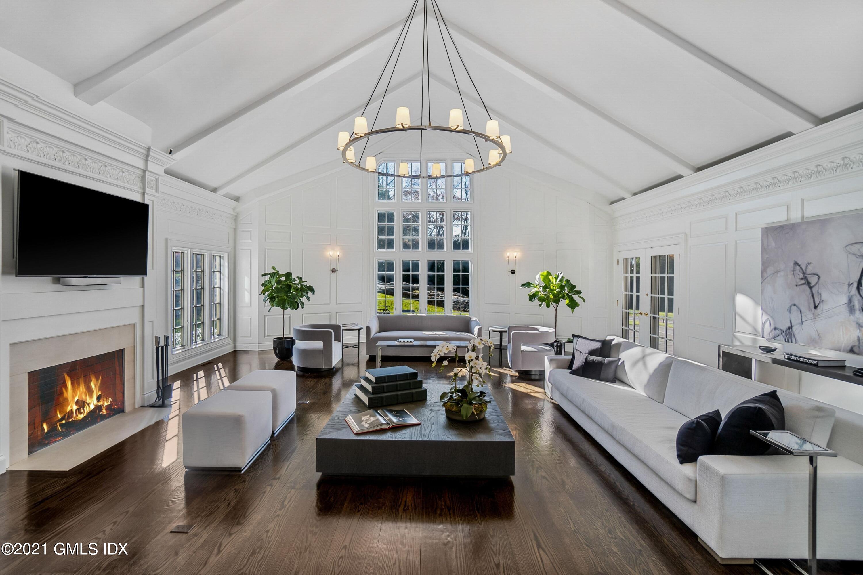 60 Round Hill Road Greenwich, CT 06831 - Photo 12 of 34 a living room with furniture a fireplace and a flat screen tv