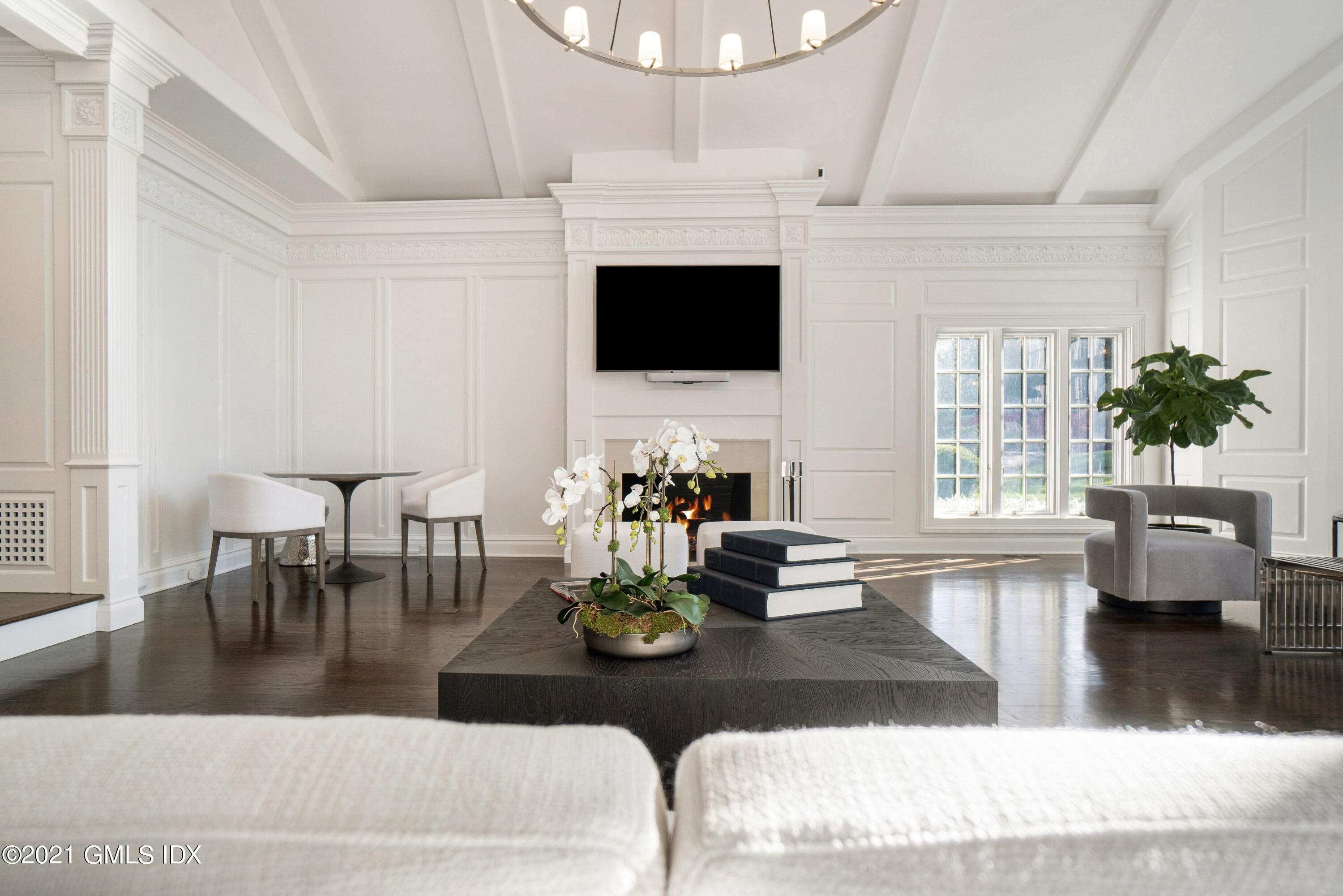 60 Round Hill Road Greenwich, CT 06831 - Photo 15 of 34 a living room with fireplace furniture and a flat screen tv