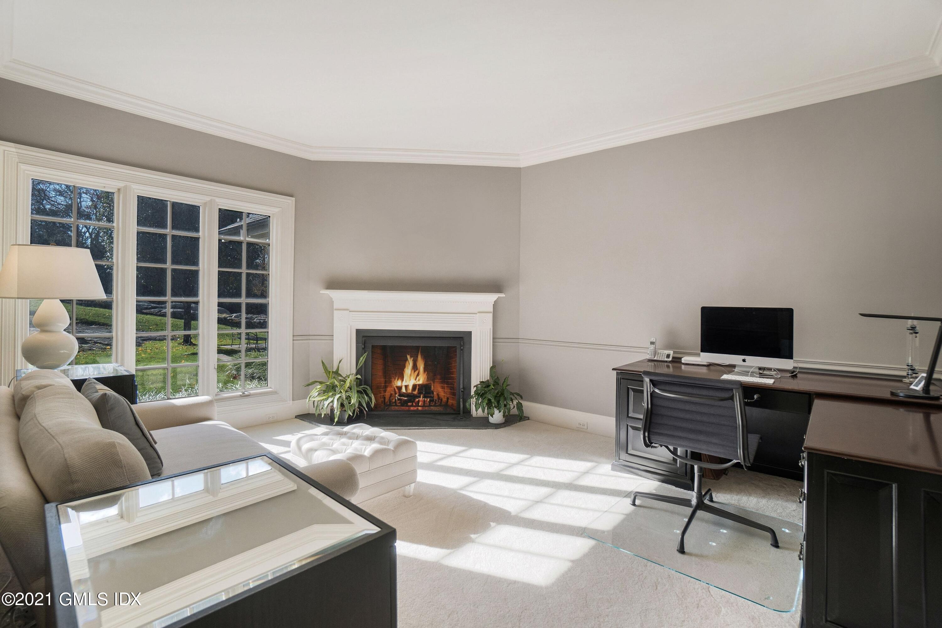 60 Round Hill Road Greenwich, CT 06831 - Photo 22 of 34 a living room with furniture and a fireplace